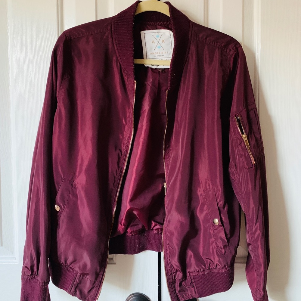 Maroon bomber jacket with gold zippers